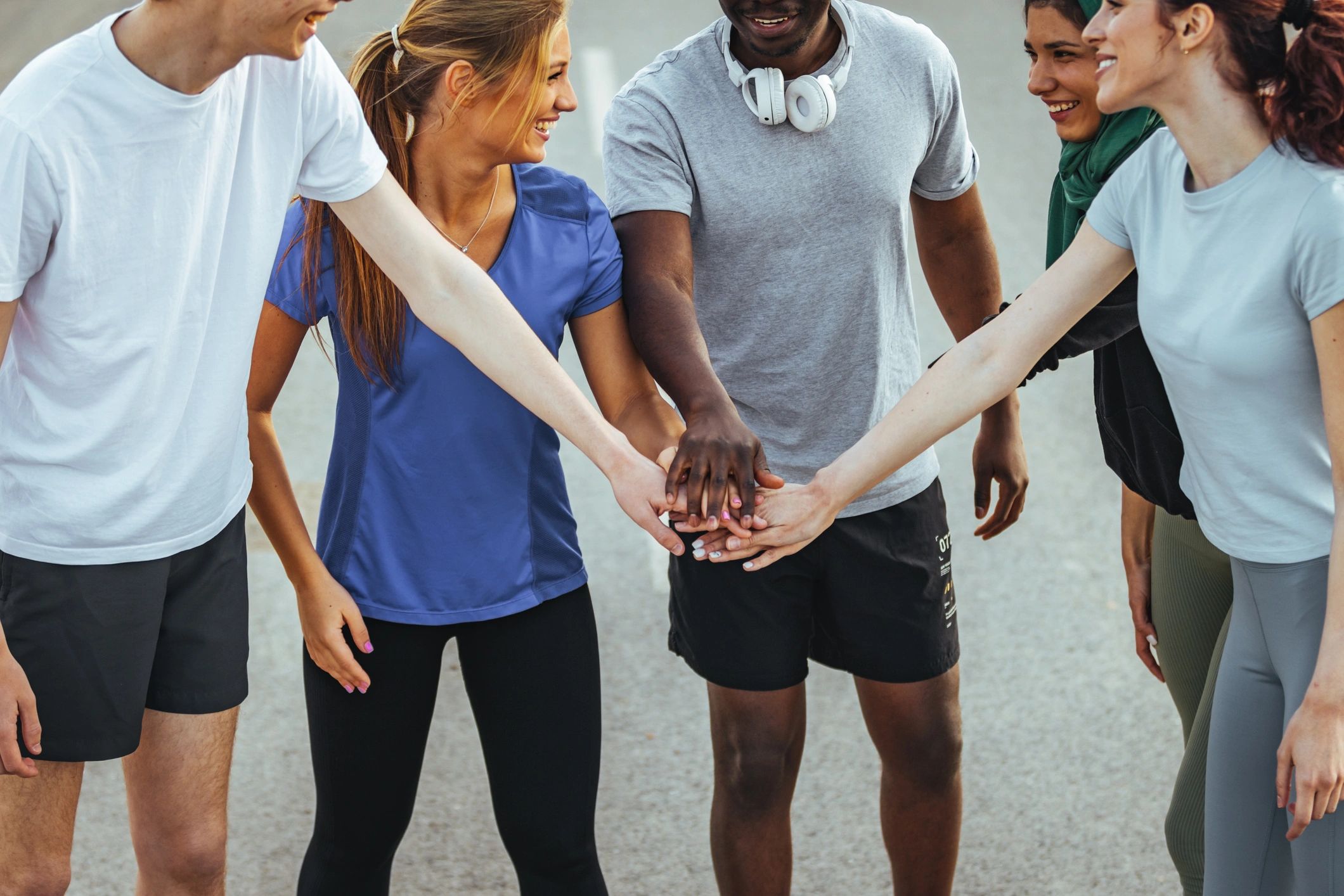 Group of runners celebrating and high-fiving after finishing