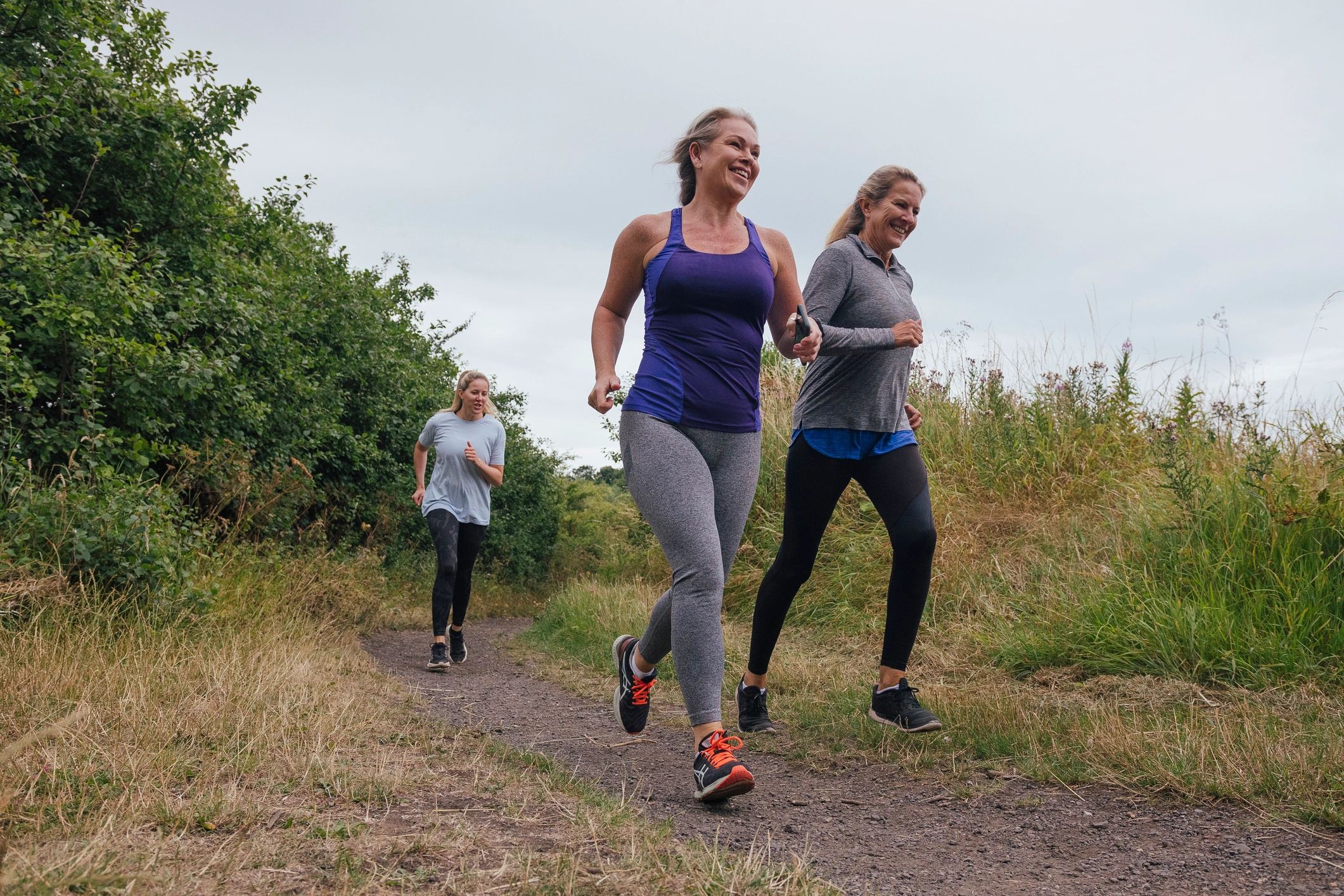 Group of women running together outdoors