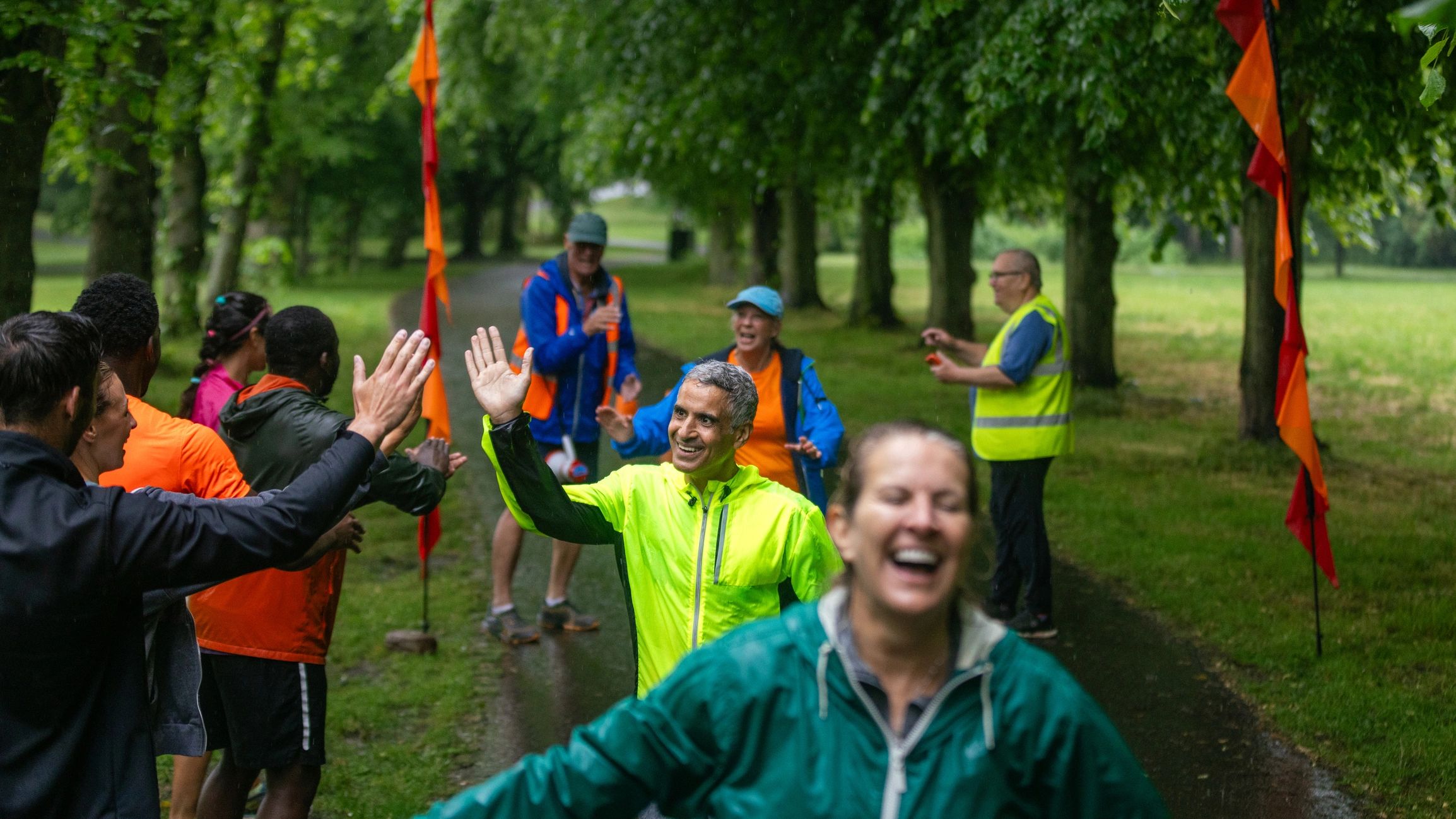 Finishers celebrating at the finish line with volunteers cheering