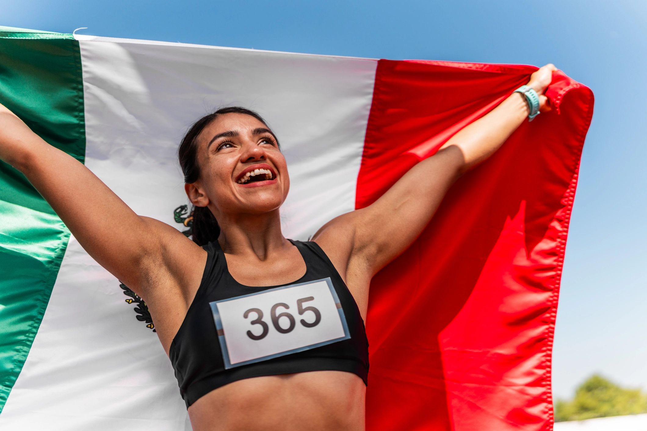 Runner celebrating with a medal after finishing a race