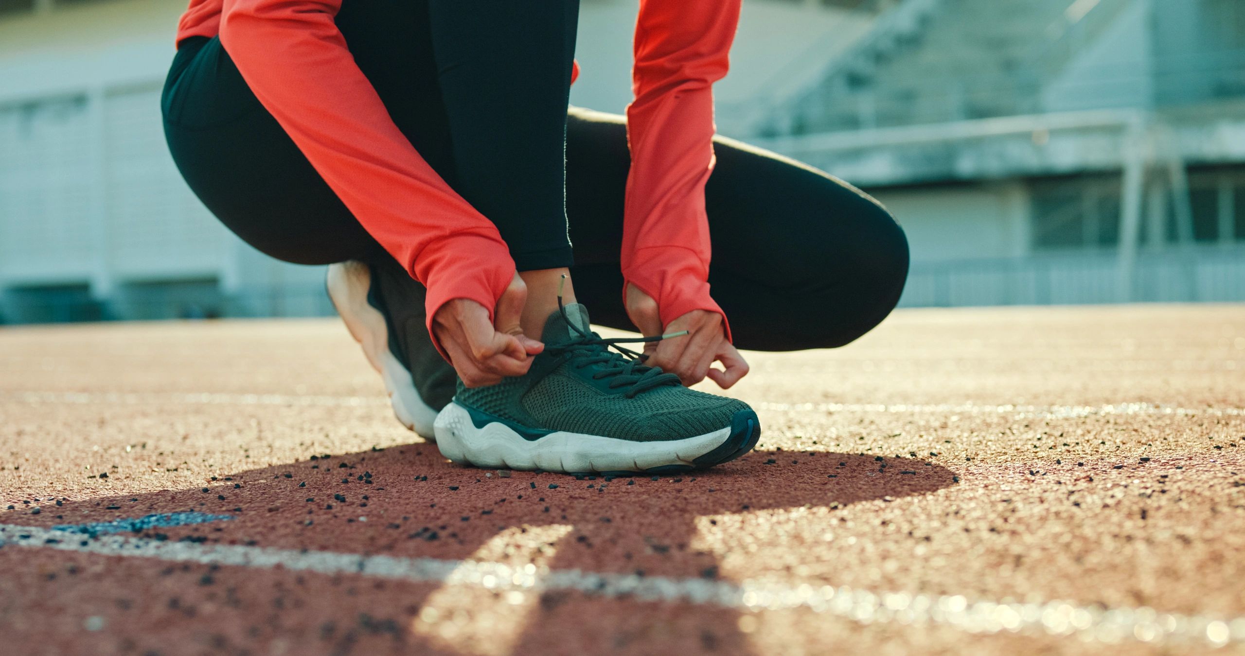 Runner tying shoelaces while preparing for a run