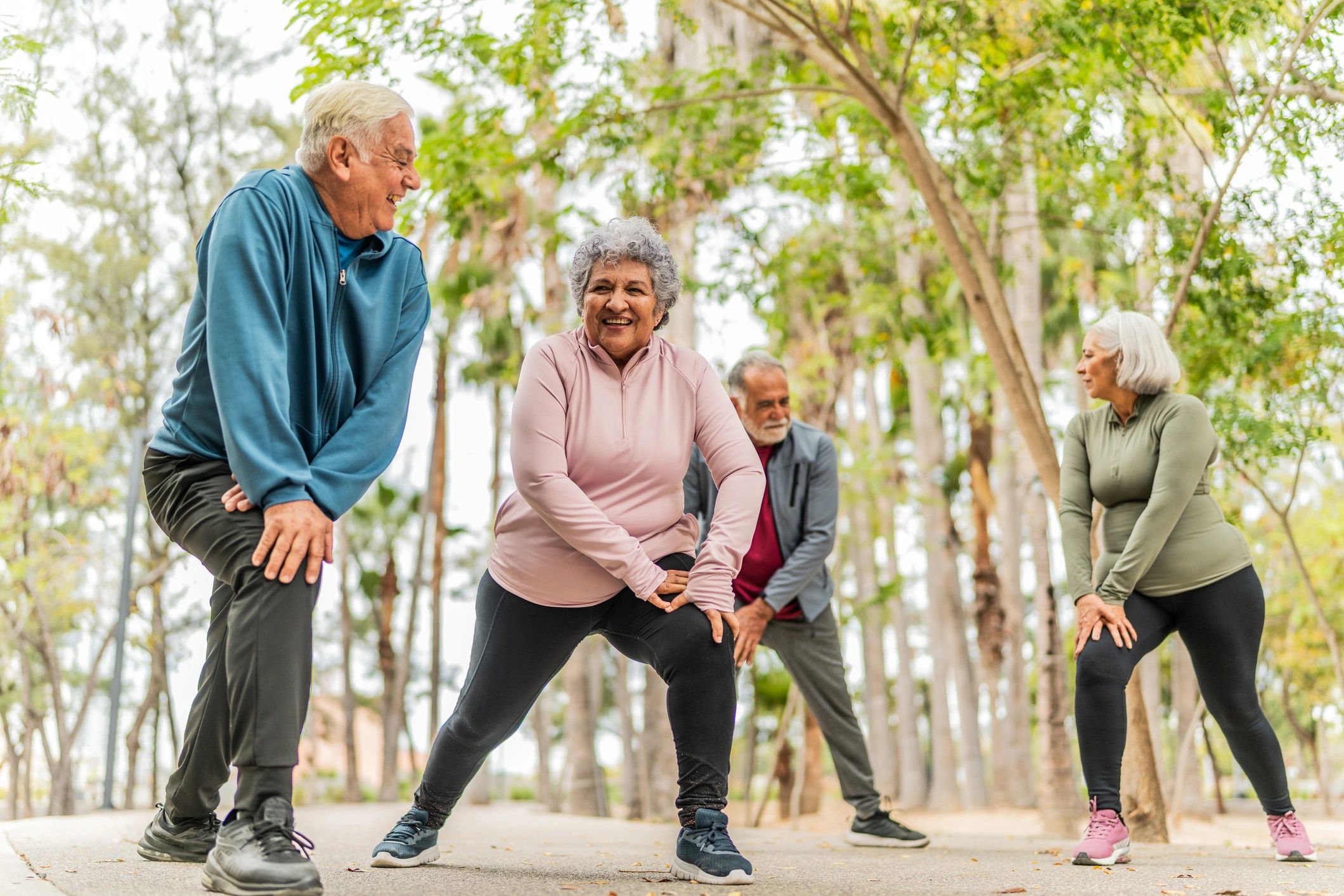 Participants stretching and warming up together in a park