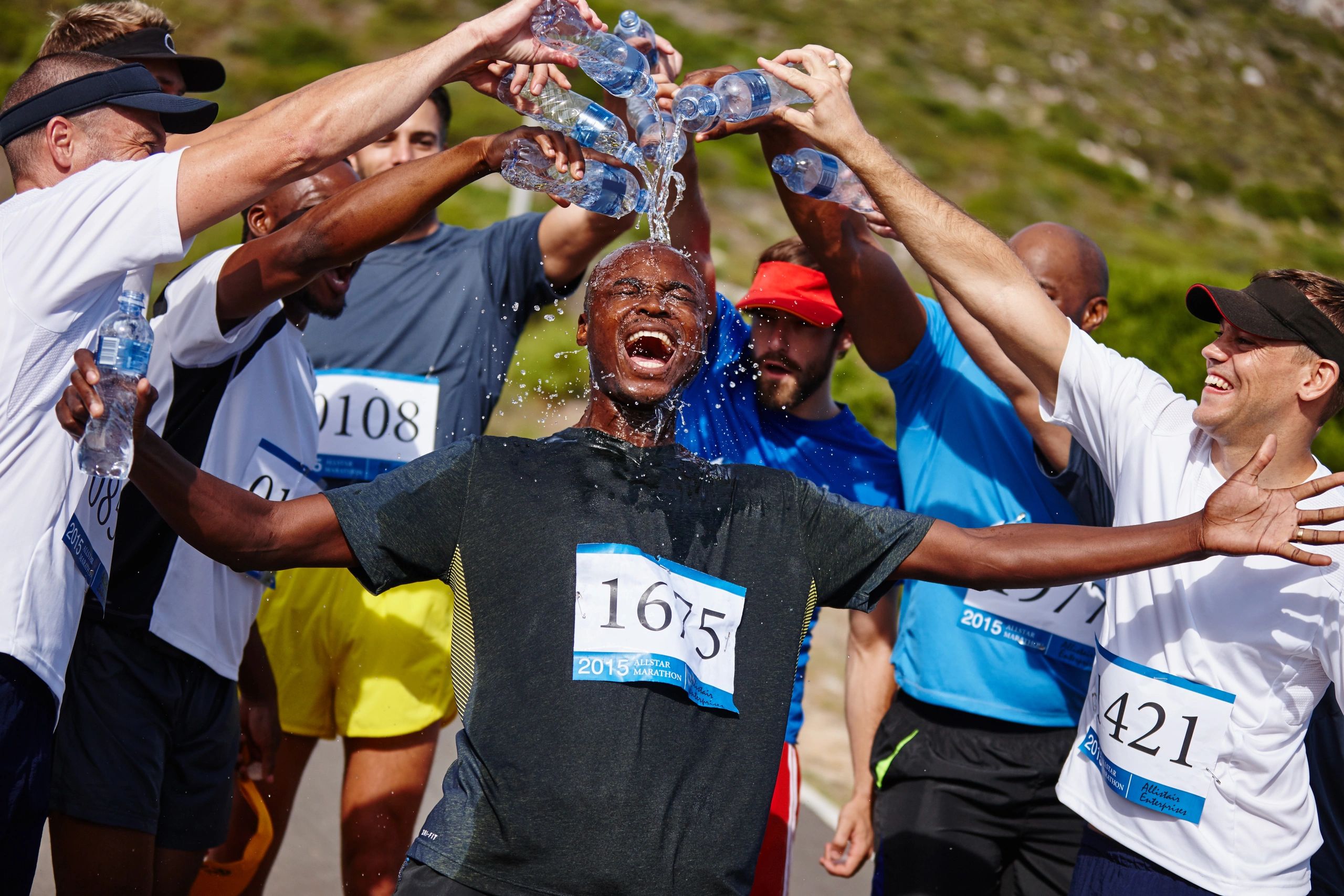 Runners cooling down with water after a race